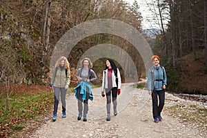 Women hikers with backpacks in the mountains