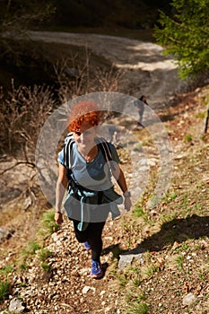 Women hikers with backpacks in the mountains