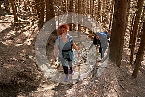 Women hikers with backpacks in the mountains