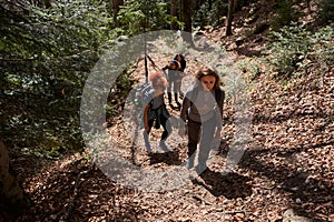 Women hikers with backpacks in the mountains