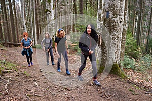 Women hikers with backpacks in the mountains