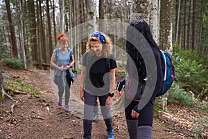 Women hikers with backpacks in the mountains