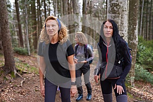 Women hikers with backpacks in the mountains