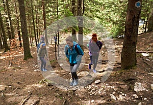 Women hikers with backpacks in the mountains