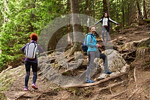 Women hikers with backpacks in the mountains