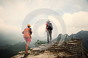 women hikers enjoy the view on the top of great wall