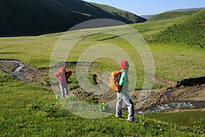 women hiking in riverside mountains