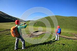 Women hiking in riverside mountains