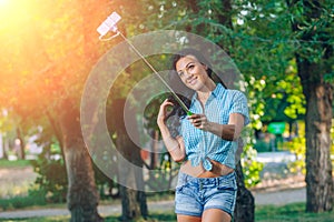 Women hold monopod use smart phone take photograph