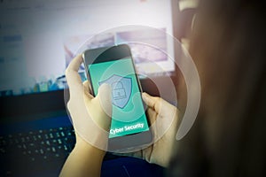 Women hold smart phone connect security with shield icon to laptop computer,concept cyber security theft prevention financial and