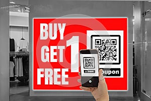 Women hold smartphone in hand, scan store QR code to e- coupon check price receive promotion and discount,cashless society concept