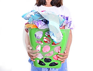 Women hold unwashed cloth in the basket