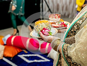 Women holding candles for mendhi henna wedding