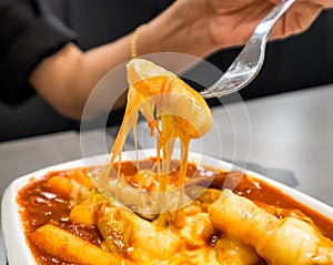 Women holding fork with tteokbokki cheese photo