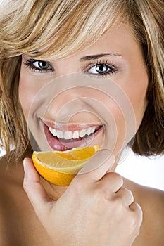 women holding fresh orange, promoting healthy lifestyle