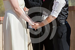 Women Holding Hands in Wedding Ceremony