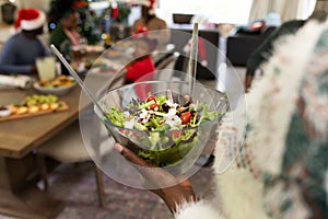 Women holding salad african american family spending time together and having meal