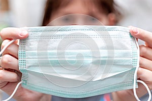 Women holds a face mask as preventive measure of coronavirus COVID-19at hospital