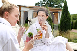 Women at the hotel pool. Rest in a holiday resort. Summer getaway.