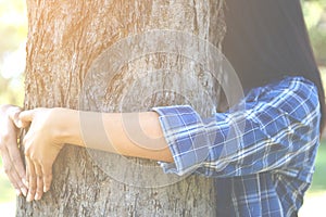 Women hug big tree