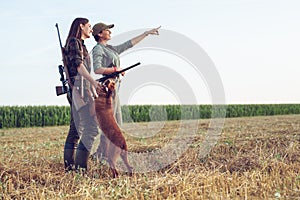 Women hunters with hunting dog