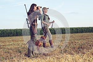 Women hunters with hunting dog