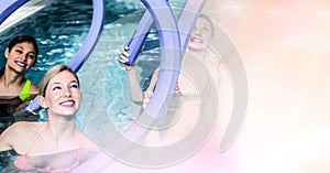 Women with inflatable sticks in swimming pool