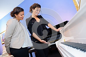 Women inside piano shop