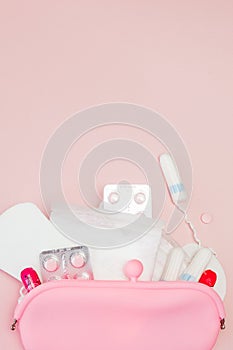 Women intimate hygiene products - sanitary pads and tampons on pink background, copy space. Menstrual period concept. Top view,