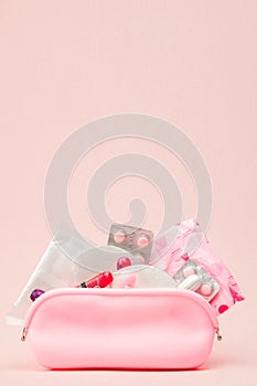 Women intimate hygiene products - sanitary pads and tampons on pink background, copy space. Menstrual period concept. Top view,