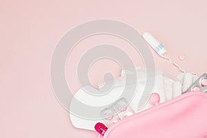 Women intimate hygiene products - sanitary pads and tampons on pink background, copy space. Menstrual period concept. Top view,