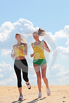 Women jogging on beach