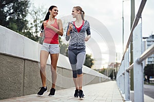 Women jogging in city in dusk