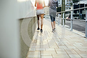 Women jogging in city in dusk