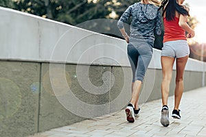 Women jogging in city in dusk