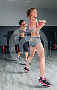 Women jumping in boxing training on gym