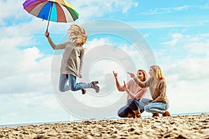 Women jumping with umbrella