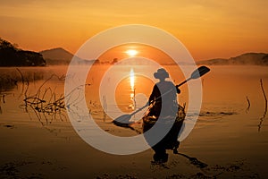 Women on kayak rows in the reservoir during the sunrise