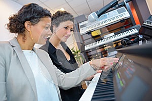 women at keyboard shop