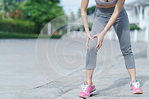 Women with knee pain. Sport exercising injury. Woman in pain while running