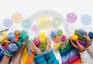 The women knit and crochet colored fabric. View from above.