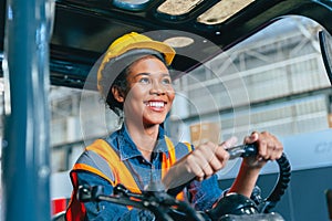 Women labor worker at forklift driver happy smile enjoy working in industry factory logistic shipping warehouse