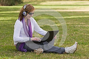 Women with laptop and earphones