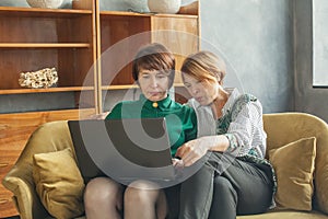 Women with laptop indoors lady 40s and 60s years old