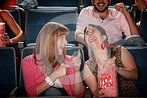 Women Laugh in a Theater