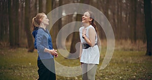 Women laughing while standing in garden