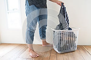 Women with laundry basket on floor