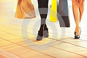 Women legs with shopping bags going to big sale