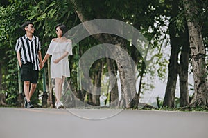 Women LGBT lesbian couple holding hands walking outdoor