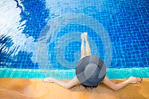 Women lifestyle relaxing near luxury swimming pool sunbath, summer day at the beach resort in the hotel.